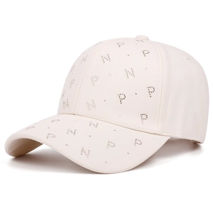 Detail of cream baseball cap with rhinestone PN letter pattern and twill cotton texture