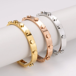 Punk style stainless steel rivet bangle available in gold, silver, and rose gold finishes