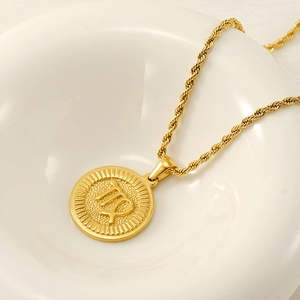 Macro detail of golden Virgo constellation pendant with textured edges and twisted chain