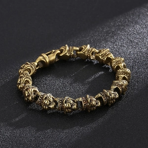 Detailed view of vintage bronze lion head embossed beads and clasp on men's rocker bracelet