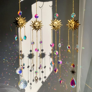 Set of four gold sun face crystal suncatchers with prism balls creating rainbow light