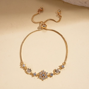 Detailed close-up of adjustable gold snowflake flower bracelet with sparkling crystals