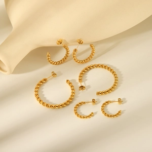 Three pairs of twisted rope gold hoop earrings in small, medium, and large sizes