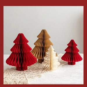Detailed close-up of foldable honeycomb paper Christmas trees in various sizes and colors