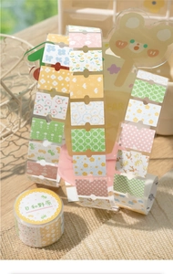 Floral and plaid patterned washi tape rolls shown with cute acrylic bear stand detail