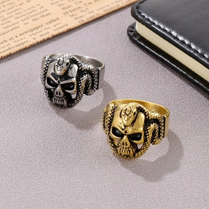 Detailed view of punk skull and snake rings in gold and silver matte finish