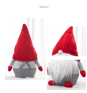 Close-up of red knitted hat and white faux fur beard on a plush Santa gnome doll
