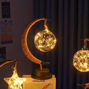 Detailed close-up of a moon-shaped iron lamp with hemp rope and warm LED glass globe