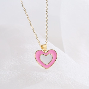 Minimalist 18K gold plated heart necklace with pink and white enamel on a soft background
