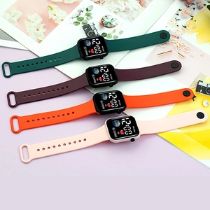 Detailed view of four colorful digital sports watches with silicone straps and UI display
