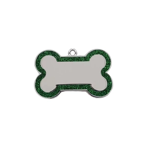 Macro detail of bone-shaped pet tag with green glitter border and polished metal surface