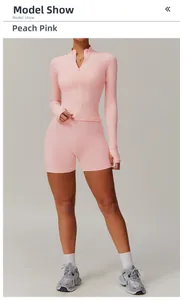 Peach pink quick-dry yoga set with high-neck zip jacket and athletic shorts on model