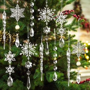 Close-up of clear acrylic snowflake and icicle ornaments hanging on a Christmas tree