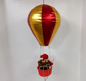 Detail of red and gold Christmas hot air balloon ornament with Santa Claus in a woven basket