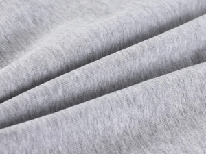 Close-up of grey knitted fabric texture showing fine weave and soft material detail