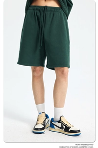Close-up of dark green men's cotton sports shorts with elastic drawstring waistband
