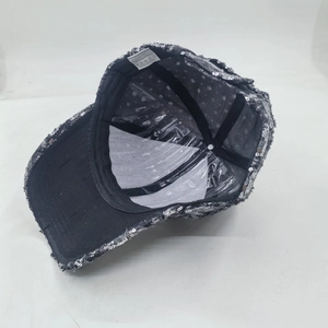 Interior view of black sequin baseball cap showing sweatband and white care label detail