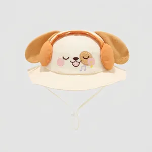 Detail of baby sun hat with cute puppy embroidery and plush ears on cream cotton fabric