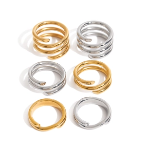 Set of 6 minimalist spiral stainless steel rings in gold and silver finish on white background
