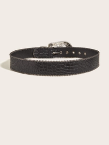 Detailed macro view of vintage silver-tone buckle on black crocodile textured belt