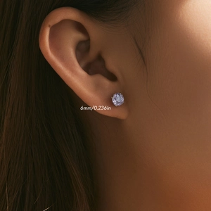 Micro shot of 6mm purple rose cut faux amethyst stud earring on an ear lobe