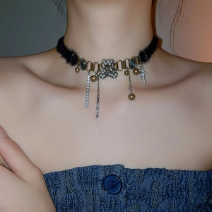 Detailed view of plush choker featuring rhinestone bear and pearl fringe tassels