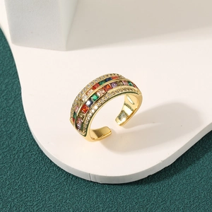 Luxury gold open ring with colorful square zircons and white crystals on white stand