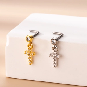 Detailed close-up of L-shaped nose rings with cross pendants and micro-pave zircons