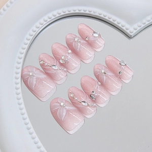 Icy pink gradient press-on nails with 3D crystal butterflies and floral accents