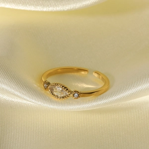 Adjustable gold plated ring with marquise cut white zircon on champagne silk fabric