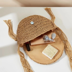 Top view of handmade straw shoulder bag showing interior space with makeup essentials