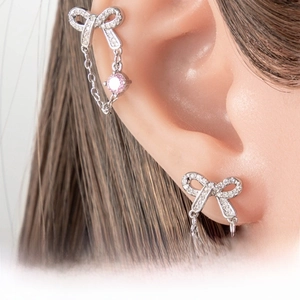 Macro view of bow tassel earring featuring 925 silver needle and pink cubic zirconia