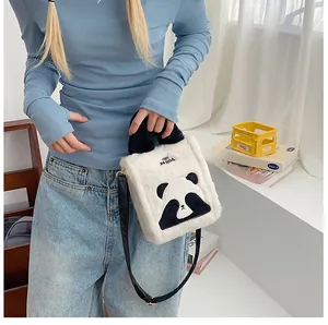 Chic panda plush handbag with metal clasps shown on a model in a minimalist setting