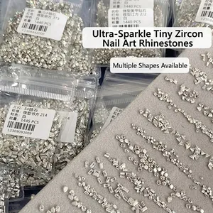 Macro detail of bulk clear crystal nail art rhinestones in various geometric shapes