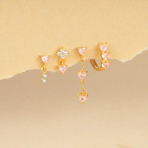 Macro detail of gold plated S925 silver set with pink heart zircon and white pearls