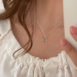 Minimalist S925 sterling silver necklace with a rectangular red gemstone pendant on a model