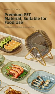 Close-up of food-grade PET plates with hammered texture and gold rim on a metal stand