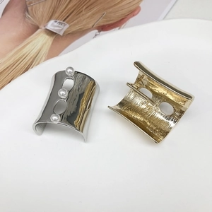 U-shaped metal hairpins set with pearls and textured finish for ponytail styling