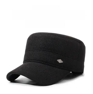 Detailed texture of black wool flat top winter cap featuring a side mountain logo badge