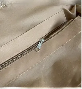 Detail view of smooth metal zipper and inner fabric lining inside paper straw beach bag