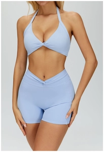 Detail of light blue halter yoga set featuring twist-front bra and V-cross waist shorts
