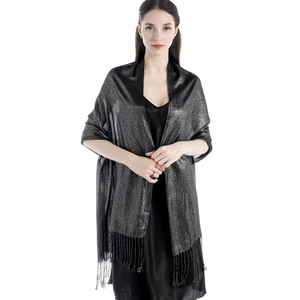 Close-up of black shawl with metallic silver threads and tassel fringe details