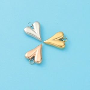 Three heart-shaped metal pendants in silver, gold, and rose gold on a light blue background