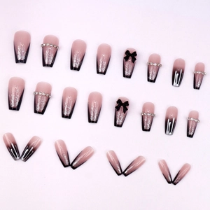 Pink and black gradient press-on nails with bow knots and glitter in ballerina shape