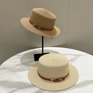 Detail of fine straw boater hat with brown leather band and gold double ring buckle