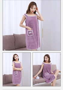 Detail view of purple coral fleece wearable bath towel with straps and bow pocket