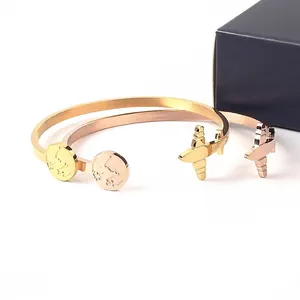 C-shaped stainless steel airplane and world map cuff bangle in gold and rose gold