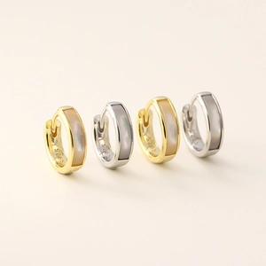 Elegant S925 silver shell earrings in gold and silver finish on a neutral background