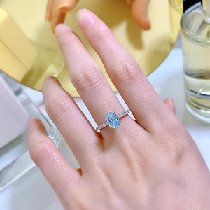 Detailed macro view of 925 silver ring featuring an oval blue stone and pavé diamonds