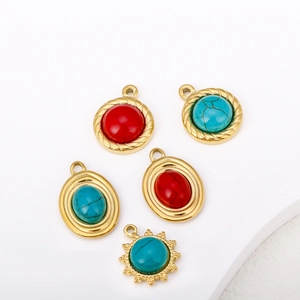Detailed shot of 18K gold plated sun pendants with turquoise and red stones